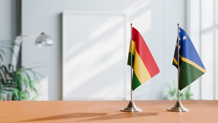FLAGS OF BOLIVIA AND SOLOMON ISLANDS ON TABLE