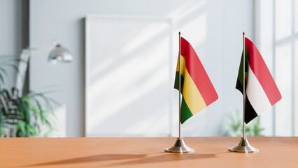 FLAGS OF BOLIVIA AND SUDAN ON TABLE