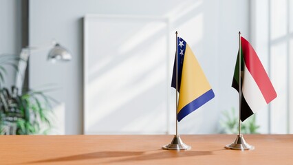 FLAGS OF BOSNIA AND SUDAN ON TABLE
