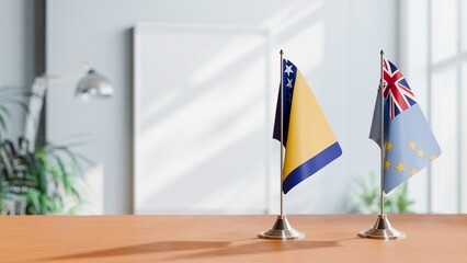 FLAGS OF BOSNIA AND TUVALU ON TABLE
