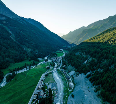Aerial view of serene and picturesque mountain valley with a river and forest, Cogne, Italy.