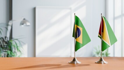 FLAGS OF BRAZIL AND GUYANA ON TABLE