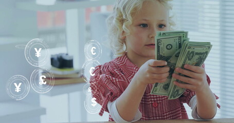 Image of currency icons data processing over caucasian girl playing with banknotes