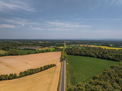 Aerial view of tranquil and picturesque Parc des Oiseaux surrounded by lush farmland and serene countryside, Marlieux, France.