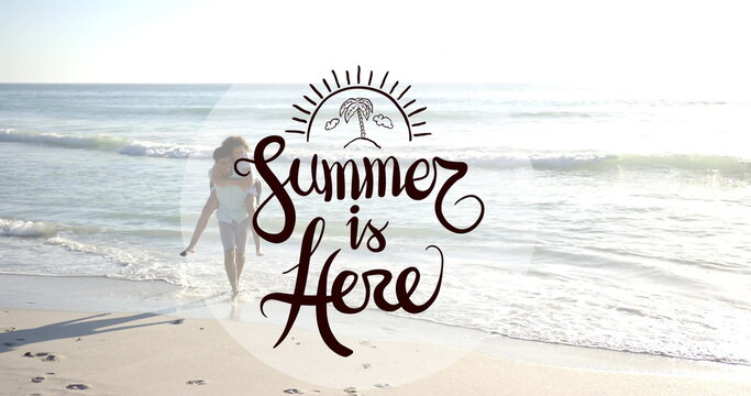 Image of summer is here text over diverse couple walking on beach