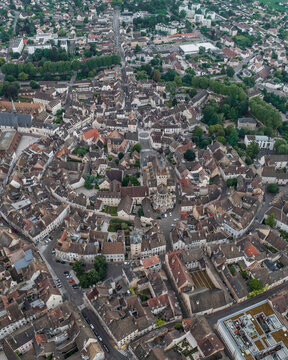 Aerial view of Notre Dame de Beaune surrounded by charming medieval buildings and quaint streets, Beaune, France.
