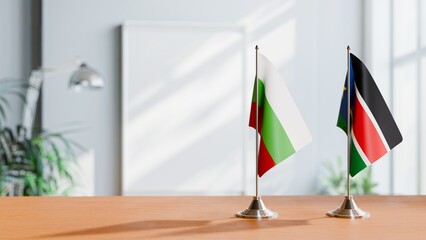 FLAGS OF BULGARIA AND SOUTH SUDAN ON TABLE