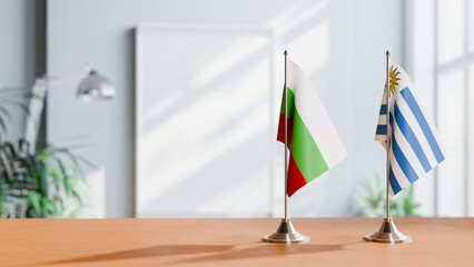 FLAGS OF BULGARIA AND URUGUAY ON TABLE