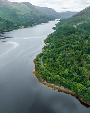 Aerial view of loch leven surrounded by lush greenery and majestic mountains, Ballachulish, United Kingdom.