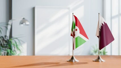 FLAGS OF BURUNDI AND QATAR ON TABLE