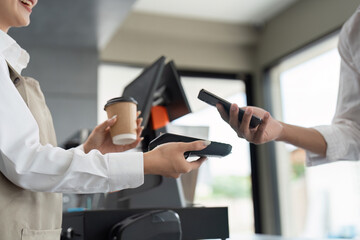 Customer Making Contactless Payment with Smartphone at Coffee Shop Counter