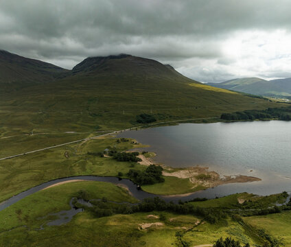 Aerial view of Loch Tulla surrounded by majestic mountains and serene valleys, Bridge of Orchy, United Kingdom.