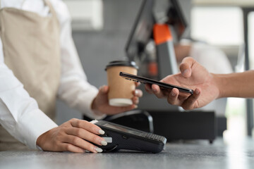 Customer Making Contactless Payment with Smartphone at Coffee Shop Counter