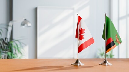 FLAGS OF CANADA AND ZAMBIA ON TABLE