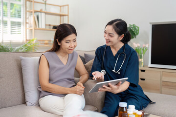 Healthcare Professional Discussing Medical Information with a Patient on a Tablet in a Comfortable Home Setting