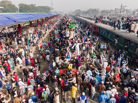 Dhaka, Bangladesh - 03 February 2024: Aerial view of overcrowded Bishwa Ijtema festival at Tongi rail station with trains and large groups of people, Dhaka, Bangladesh.