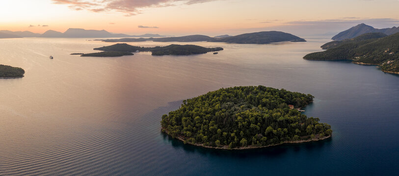 Aerial view of a beautiful island at sunrise surrounded by the tranquil Ionian Sea, Lefkada, Greece.