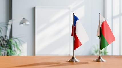 FLAGS OF CHILE AND MADAGASCAR ON TABLE