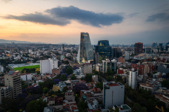 Aerial view of manacar tower and vibrant cityscape at sunset, benito juarez, mexico.