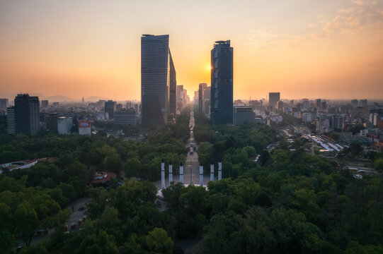 Aerial view of the vibrant skyline and majestic Castillo de Chapultepec surrounded by Bosque de Chapultepec park at sunrise, Miguel Hidalgo, Mexico.