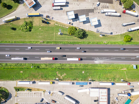 Aerial view of a busy highway with trucks and a gas station, Santa Maria di Campagna, Cessalto, Treviso, Italy.
