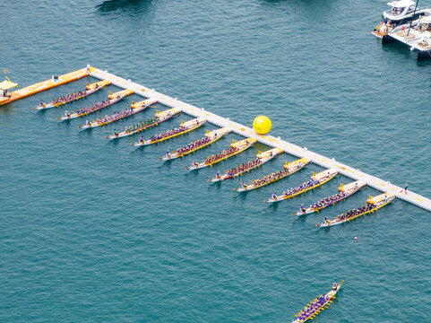 Aerial view of colorful dragon's boat races with people and boats on the water, Stanley, Hong Kong.