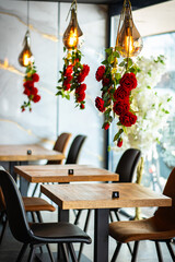 A beautifully designed restaurant interior showcasing a modern and elegant dining area. The space features contemporary furniture, including wooden chairs and tables set with glassware, plates.