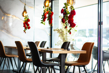 A beautifully designed restaurant interior showcasing a modern and elegant dining area. The space features contemporary furniture, including wooden chairs and tables set with glassware, plates.