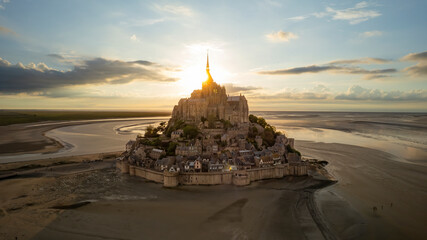 Aerial view of mont saint michel at sunset with beautiful architecture and scenic coastline, mont saint michel, france.