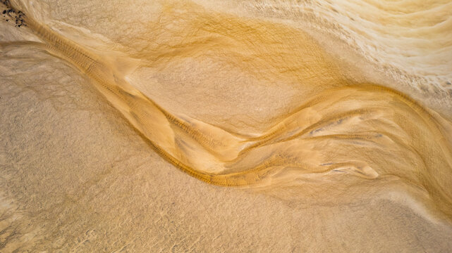 Aerial view of abstract patterns and textures of sandy Eoropie Beach, Ness, Isle of Lewis, Scotland.
