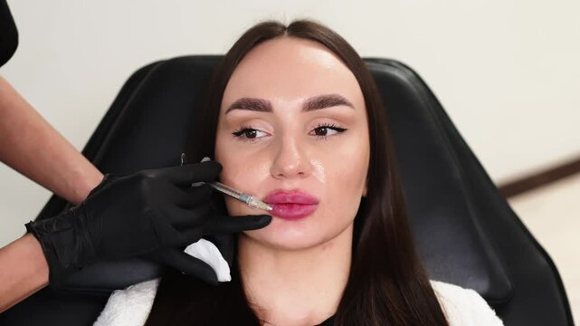 Close-up of sensual female lips with a syringe administering injections. The scene highlights a lip augmentation procedure, focusing on precision in enhancing lip shape.