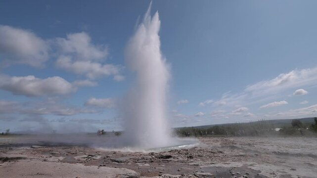 Slowmotion video of strokkur geothermal geyser erupting in iceland, view of a eruption of water from the volcaning underground in iceland