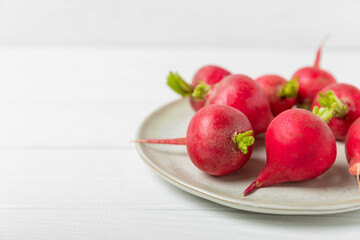 Fresh radish on textured wooden background. Organic natural garden radish slices. clipping root crop. Vegetables. Vegan. Diet products. Healthy food. Place for text. Copy space.