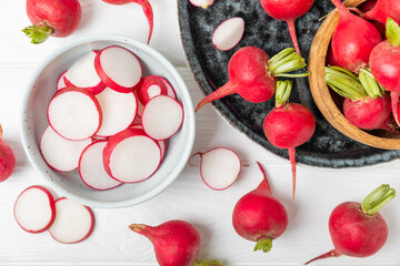 Fresh radish on textured wooden background. Organic natural garden radish slices. clipping root crop. Vegetables. Vegan. Diet products. Healthy food. Place for text. Copy space.