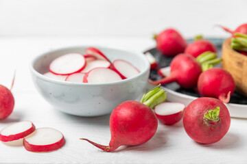 Fresh radish on textured wooden background. Organic natural garden radish slices. clipping root crop. Vegetables. Vegan. Diet products. Healthy food. Place for text. Copy space.