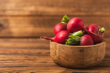 Fresh radish on textured wooden background. Organic natural garden radish slices. clipping root crop. Vegetables. Vegan. Diet products. Healthy food. Place for text. Copy space.