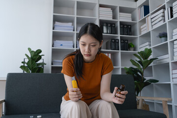 The woman, sitting on her sofa at home, stared at the cutter and the medicine bottle, overwhelmed...