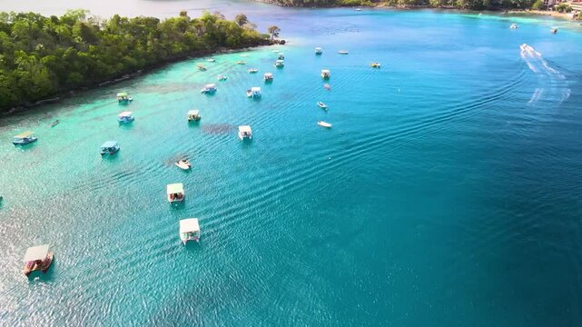 Aerial View of a Small Island with Numerous Boats Docked Along the Shore