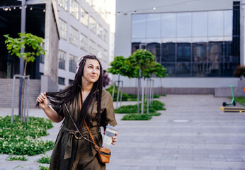 Fototapeta premium Happy mid adult woman enjoying listening to music through headphones outdoor.