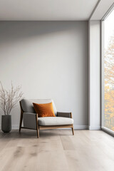 Cozy modern armchair with orange cushion in bright room overlooking a serene outdoor view during autumn