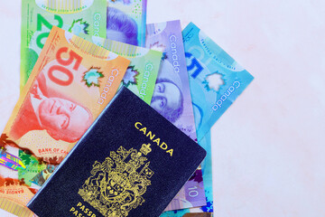 An official passport issued by Canadian government accompanied by Canadian banknotes in currency...