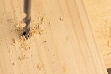 metal drill bit and pine wood board during operation