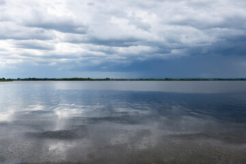 lake and trees on the shore before a storm