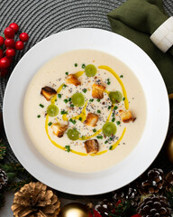 Spanish tapa cold soup of ajoblanco with grapes. Top view table with Christmas decoration.