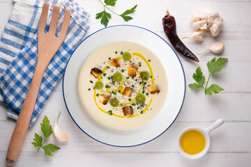 Spanish tapa cold soup of ajoblanco with grapes. Top view table with  decoration.