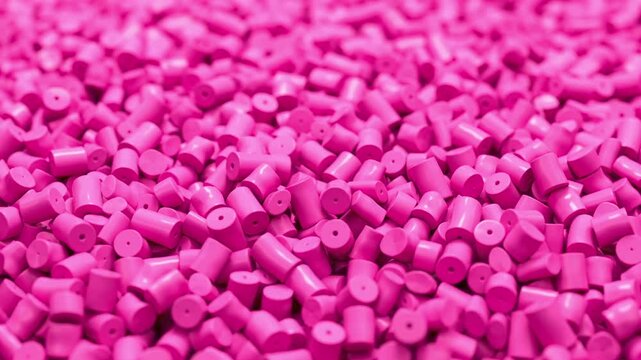 Fly around pile of pink plastic polypropylene granules, masterbatch polymer grain. HDPE or PVC resin pellets. 3d render animation