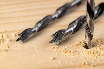 metal drill bit and pine wood board during operation