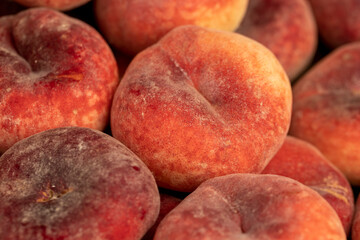 a pile of ripe washed peaches on the table