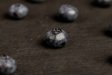 blueberries scattered on a black slate board