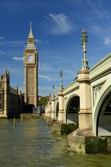 Naklejka premium Parliament building and Westminster bridge, London, England, U.K. The Cities government with Big Ben clock tower and the river Thames on a sunny September day.